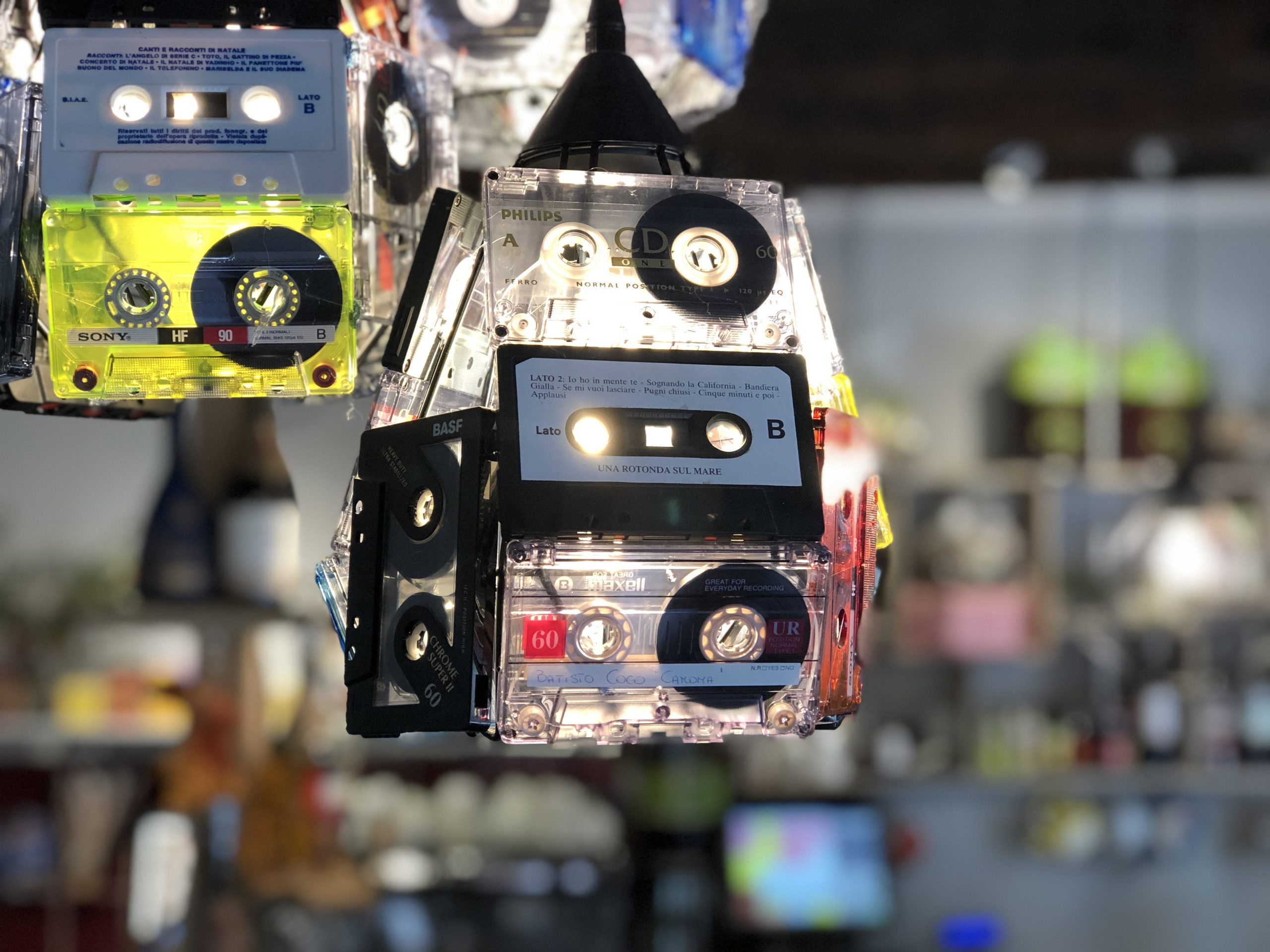 Creative upcycled cassette tape lighting fixture in a Venice restaurant, showcasing innovative design in marketing.